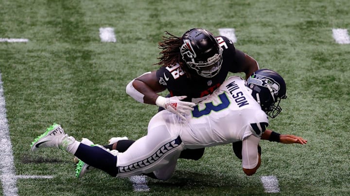 ATLANTA, GEORGIA - SEPTEMBER 13: Takkarist McKinley #98 of the Atlanta Falcons sacks Russell Wilson #3 of the Seattle Seahawks in the first half at Mercedes-Benz Stadium on September 13, 2020 in Atlanta, Georgia. (Photo by Kevin C. Cox/Getty Images)