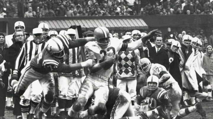 CLEVELAND – DECEMBER 27: Jim Brown #32 of the Cleveland Browns carries the ball against Billy Ray Smith Sr. #74 of the Baltimore Colts as Bobby Boyd #40 and Monte Clark #73 look on during the 1964 NFL Championship game at Cleveland Stadium on December 27, 1964 in Cleveland, Ohio. (Photo by Robert Riger/Getty Images)