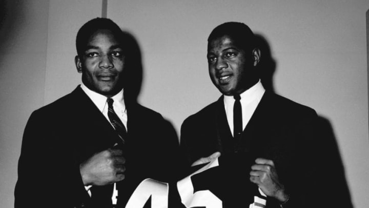 HIRAM, OH - JULY, 1961: (L to R) Runningbacks Jim Brown #32 and Ernie Davis #45, of the Cleveland Browns, poses together during training camp in July, 1961 at Hiram College in Hiram, Ohio. Both Brown and Davis were runningbacks at Syracuse University and wore uniform number 44. (Photo by: Henry Barr Collection/Diamond Images/Getty Images)