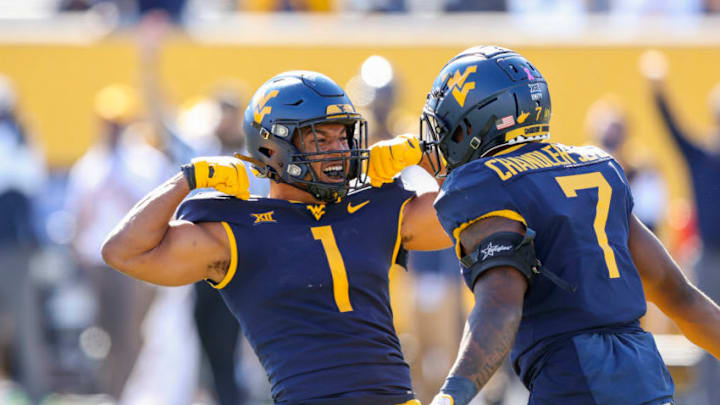 Oct 17, 2020; Morgantown, West Virginia, USA; West Virginia Mountaineers linebacker Tony Fields II (1) celebrates with linebacker Josh Chandler-Semedo (7) after a defensive stop during the third quarter against the Kansas Jayhawks at Mountaineer Field at Milan Puskar Stadium. Mandatory Credit: Ben Queen-USA TODAY Sports