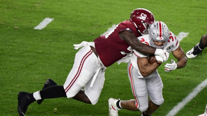 Jan 11, 2021; Miami Gardens, FL, USA; Ohio State Buckeyes running back Master Teague III (33) is tackled by Alabama Crimson Tide defensive lineman Christian Barmore (58) in the second quarter in the 2021 College Football Playoff National Championship Game at Hard Rock Stadium. Mandatory Credit: Douglas DeFelice-USA TODAY Sports