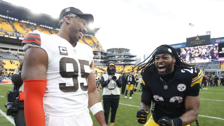 Jan 8, 2023; Pittsburgh, Pennsylvania, USA; Cleveland Browns defensive end Myles Garrett (95) and Pittsburgh Steelers running back Najee Harris (22) share a laugh on the field after their game at Acrisure Stadium. Pittsburgh won 28-14. Mandatory Credit: Charles LeClaire-USA TODAY Sports