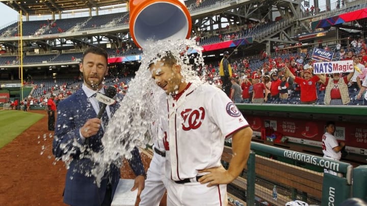 Apr 24, 2016; Washington, DC, USA; Washington Nationals center fielder Chris Heisey (14) gets a bucket of ice water dumped on him by Nationals third baseman Anthony Rendon (6) while being interviewed by MASN reporter Dan Kolko (L) after hitting a walk-off home run against the Minnesota Twins in the sixteenth inning at Nationals Park. The National won 5-4 in sixteen innings. Mandatory Credit: Geoff Burke-USA TODAY Sports