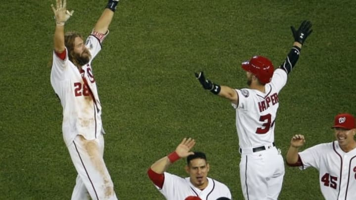 Jun 15, 2016; Washington, DC, USA; Washington Nationals left fielder Jayson Werth (28) celebrates with Nationals right fielder Bryce Harper (34) after hitting the game-winning single against the Chicago Cubs in the twelfth inning at Nationals Park. The Nationals won 5-4. Mandatory Credit: Geoff Burke-USA TODAY Sports