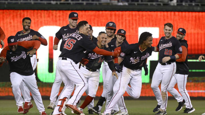 WASHINGTON, DC - SEPTEMBER 28: CJ Abrams #5 of the Washington Nationals celebrates with teammates after driving in the game winning run with a single in the tenth inning against the Atlanta Braves at Nationals Park on September 28, 2022 in Washington, DC. (Photo by Greg Fiume/Getty Images)
