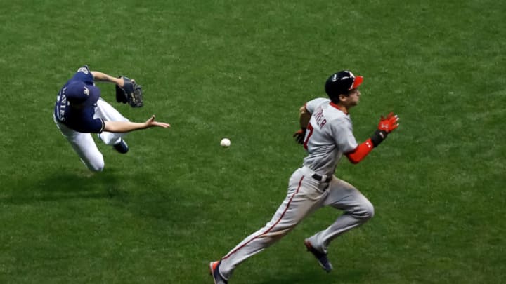 MILWAUKEE, WI - AUGUST 31: Zach Davies #27 of the Milwaukee Brewers tosses the ball to first base as Trea Turner #7 of the Washington Nationals reaches safely on a bunt during the fifth inning at Miller Park on August 31, 2017 in Milwaukee, Wisconsin. (Photo by Jon Durr/Getty Images)