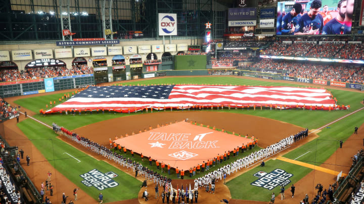 HOUSTON, TEXAS – OCTOBER 22: An American flag is displayed as singer-songwriter Nicole Scherzinger performs the national anthem prior to Game One of the 2019 World Series between the Houston Astros and the Washington Nationals at Minute Maid Park on October 22, 2019 in Houston, Texas. (Photo by Bob Levey/Getty Images)