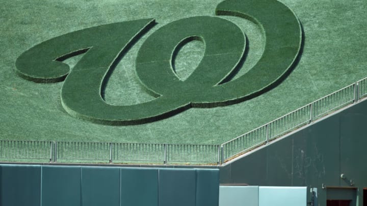 The Washington Nationals logo in centerfield grass before a baseball game against the Los Angeles Dodgers at Nationals Park on July 26, 2019 in Washington, DC. (Photo by Mitchell Layton/Getty Images) *** Local Caption ***