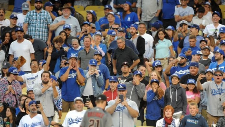 September 5, 2016; Los Angeles, CA, USA; Los Angeles Dodgers fans watch as Arizona Diamondbacks center starting pitcher Zack Greinke (21) walks to the dugout after being relieved in the fifth inning at Dodger Stadium. Mandatory Credit: Gary A. Vasquez-USA TODAY Sport