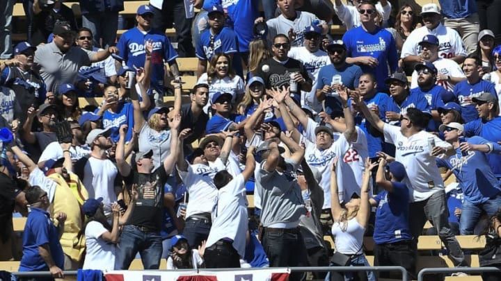 LOS ANGELES, CA - MARCH 28: Fans reach for the two run home run ball hit by Enrique Hernandez #14 of the Los Angeles Dodgers against pitcher Zack Greinke #21 of the Arizona Diamondbacks during the fourth inning against Los Angeles Dodgers at Dodger Stadium on March 28, 2019 in Los Angeles, California. (Photo by Kevork Djansezian/Getty Images)