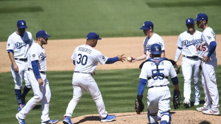 LOS ANGELES, CA - MARCH 31: Walker Buehler #21 of the Los Angeles Dodgers gives up the baseball to manager Dave Roberts #30 as he replaced after giving up three runs during the fourth inning against Arizona Diamondbacks at Dodger Stadium on March 31, 2019 in Los Angeles, California. (Photo by Kevork Djansezian/Getty Images)