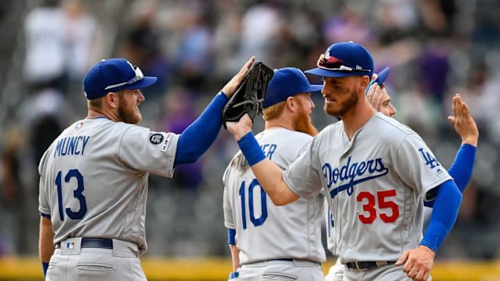 DENVER, CO - APRIL 5: Max Muncy #13 of the Los Angeles Dodgers and Cody Bellinger #35 celebrate after a 10-6 win over the Colorado Rockies during the Colorado Rockies home opener at Coors Field on April 5, 2019 in Denver, Colorado. (Photo by Dustin Bradford/Getty Images)