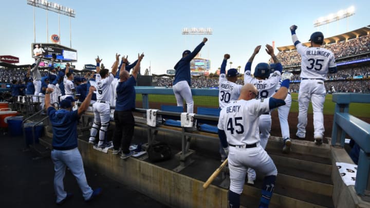 LOS ANGELES, CALIFORNIA - OCTOBER 09: The Los Angeles Dodgers dug out celebrate after Max Muncy #13 hit a two run home run in the first inning of game five of the National League Division Series against the Washington Nationals at Dodger Stadium on October 09, 2019 in Los Angeles, California. (Photo by Harry How/Getty Images)