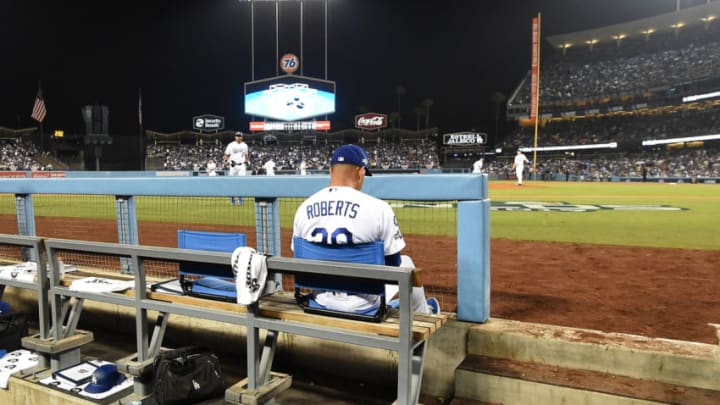 LOS ANGELES, CALIFORNIA - OCTOBER 09: Manager Dave Roberts of the Los Angeles Dodgers sits in the dug out during game five of the National League Division Series against the Washington Nationals at Dodger Stadium on October 09, 2019 in Los Angeles, California. The Nationals defeated the Dodgers 7-3 and clinch the series 3-2. (Photo by Harry How/Getty Images)