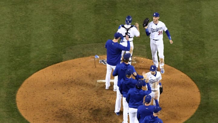 LOS ANGELES, CALIFORNIA - OCTOBER 21: Cody Bellinger #35 and AJ Pollock #11 of the Los Angeles Dodgers celebrate a 11-2 win over the Atlanta Braves during game five of the National League Championship Series at Dodger Stadium on October 21, 2021 in Los Angeles, California. (Photo by Harry How/Getty Images)