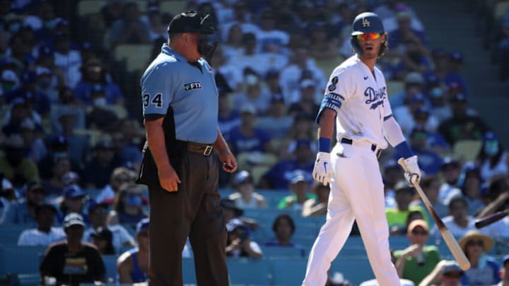 LOS ANGELES, CALIFORNIA - AUGUST 29: Cody Bellinger #35 of the Los Angeles Dodgers talks with the umpire Sam Holbrook #34 after a call during the seventh inning at Dodger Stadium on August 29, 2021 in Los Angeles, California. (Photo by Katelyn Mulcahy/Getty Images)