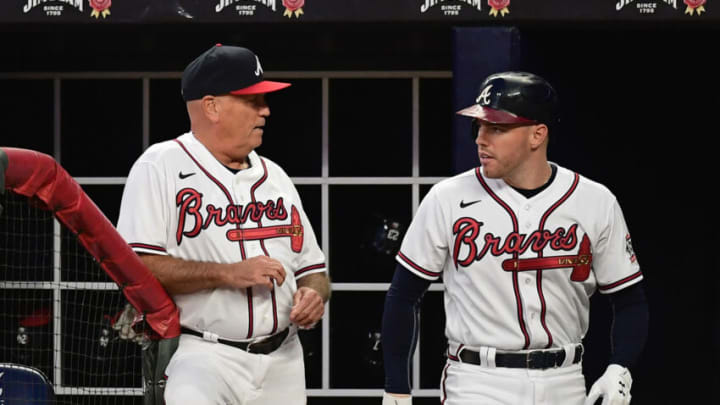 ATLANTA, GA - SEPTEMBER 28: Brian Snitker #43 of the Atlanta Braves talks with Freddie Freeman #5 during the first inning against the Philadelphia Phillies at Truist Park on September 28, 2021 in Atlanta, Georgia. (Photo by Adam Hagy/Getty Images)