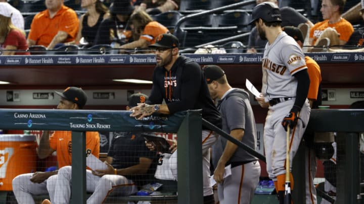 PHOENIX, ARIZONA - JULY 27: Manager Gabe Kapler #19 of the San Francisco Giants (center) looks on during the eighth inning against the Arizona Diamondbacks at Chase Field on July 27, 2022 in Phoenix, Arizona. The Diamondbacks beat the Giants 5-3. (Photo by Chris Coduto/Getty Images)