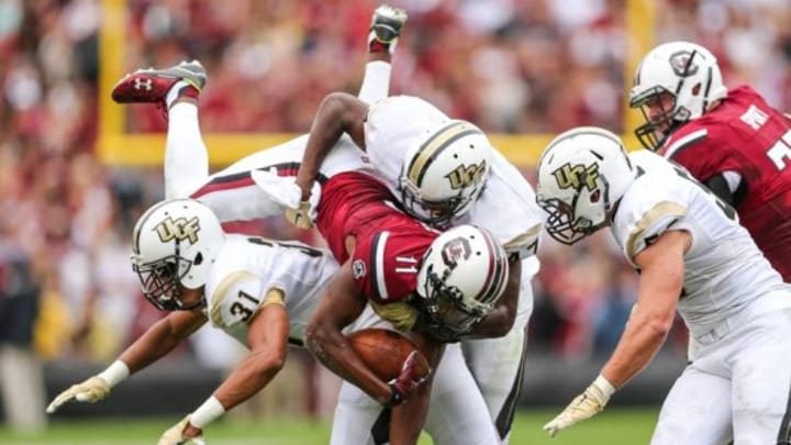 Sep 26, 2015; Columbia, SC, USA; South Carolina Gamecocks wide receiver Pharoh Cooper (11) is tackled by UCF Knights linebacker Jerod Boykin (47) and defensive back Jeremy Boykins (31) during the first quarter at Williams-Brice Stadium. Mandatory Credit: Jim Dedmon-USA TODAY Sports