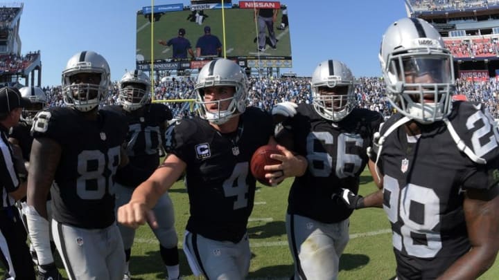 Sep 25, 2016; Nashville, TN, USA; Oakland Raiders players Clive Walford (88), Kelechi Osemele (70), Derek Carr (4), Gabe Jackson (66) and Latavius Murray (28) celebrate after defeating the Tennessee Titans 17-10 at Nissan Stadium. Mandatory Credit: Kirby Lee-USA TODAY Sports