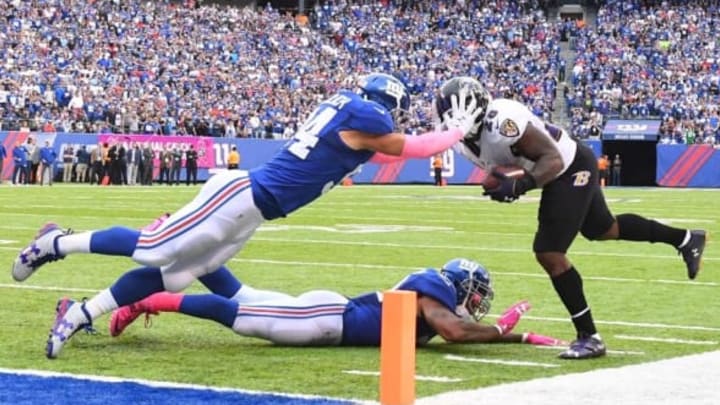 Oct 16, 2016; East Rutherford, NJ, USA;Baltimore Ravens running back Terrance West (28) is stopped short of a touchdown by New York Giants outside linebacker Mark Herzlich (94) and outside linebacker Jonathan Casillas in the 4th quarter at MetLife Stadium. Mandatory Credit: Robert Deutsch-USA TODAY Sports