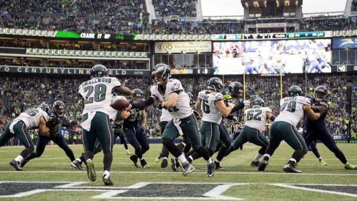 Nov 20, 2016; Seattle, WA, USA; Philadelphia Eagles quarterback Carson Wentz (11) hands off to running back Wendell Smallwood (28) during the third quarter at CenturyLink Field. The Seahawks won 26-15. Mandatory Credit: Troy Wayrynen-USA TODAY Sports