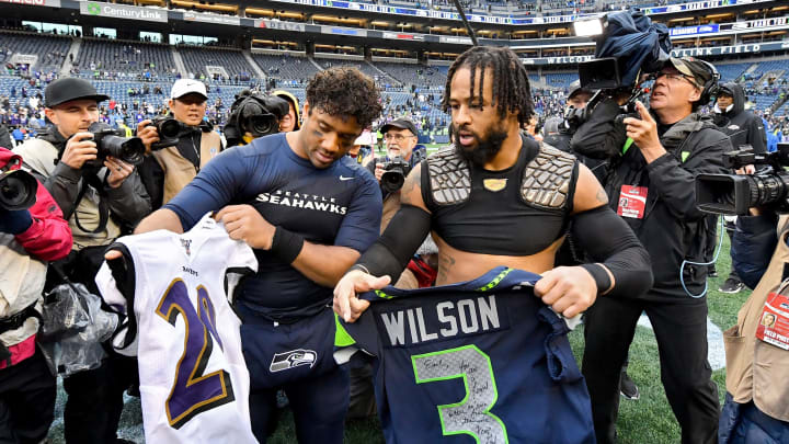 SEATTLE, WASHINGTON – OCTOBER 20: Russell Wilson #3 of the Seattle Seahawks and Earl Thomas #29 of the Baltimore Ravens exchange jerseys after the game at CenturyLink Field on October 20, 2019 in Seattle, Washington. The Baltimore Ravens top the Seattle Seahawks 30-16. (Photo by Alika Jenner/Getty Images)