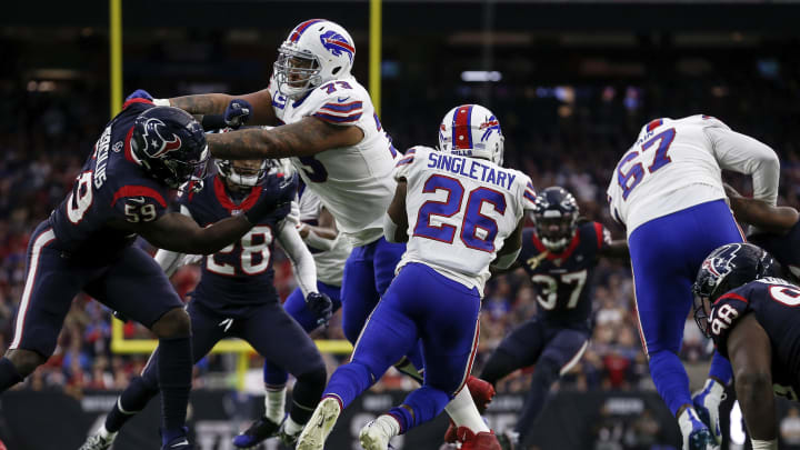 HOUSTON, TEXAS – JANUARY 04: Devin Singletary #26 of the Buffalo Bills runs the ball from the end zone as Dion Dawkins #73 blocks Whitney Mercilus #59 of the Houston Texans in the first half of the AFC Wild Card Playoff game at NRG Stadium on January 04, 2020 in Houston, Texas. (Photo by Tim Warner/Getty Images)