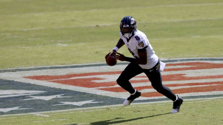 LANDOVER, MARYLAND – OCTOBER 04: Quarterback Lamar Jackson #8 of the Baltimore Ravens rolls out to pass against the Washington Football Team in the first quarter at FedExField on October 04, 2020, in Landover, Maryland. (Photo by Rob Carr/Getty Images)