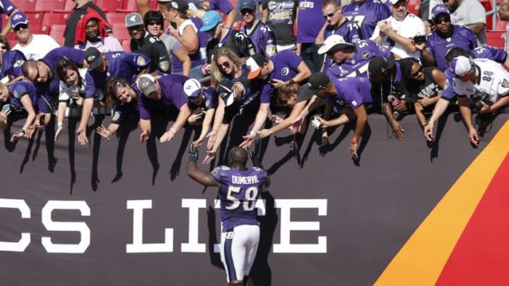 TAMPA, FL - OCTOBER 12: Elvis Dumervil #58 of the Baltimore Ravens celebrates with fans after the game against the Tampa Bay Buccaneers at Raymond James Stadium on October 12, 2014 in Tampa, Florida. The Ravens defeated the Buccaneers 48-17. (Photo by Joe Robbins/Getty Images)