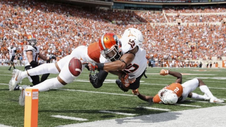 AUSTIN, TX - OCTOBER 21: DeShon Elliott #4 of the Texas Longhorns hits Chris Lacy #15 of the Oklahoma State Cowboys at the goal line forcing a fumble in the fourth quarter at Darrell K Royal-Texas Memorial Stadium on October 21, 2017 in Austin, Texas. (Photo by Tim Warner/Getty Images)