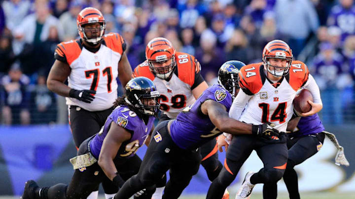 BALTIMORE, MD - NOVEMBER 10: Quarterback Andy Dalton #14 of the Cincinnati Bengals is tackled by outside linebacker Terrell Suggs #55 of the Baltimore Ravens during the fourth quarter of the Ravens 20-17 overtime win at M&T Bank Stadium on November 10, 2013 in Baltimore, Maryland. (Photo by Rob Carr/Getty Images)