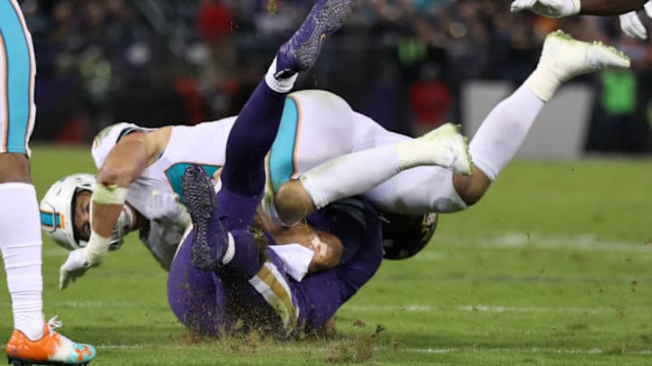 BALTIMORE, MD - OCTOBER 26: Quarterback Joe Flacco #5 of the Baltimore Ravens is hit by middle linebacker Kiko Alonso #47 of the Miami Dolphins as he slides in the second quarter against the Miami Dolphins at M&T Bank Stadium on October 26, 2017 in Baltimore, Maryland. (Photo by Patrick Smith/Getty Images)