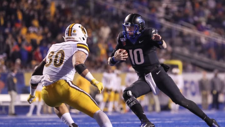 BOISE, ID – NOVEMBER 09: Quarterback Chase Cord #10 of the Boise State Broncos tries to avoid the tackle of linebacker Logan Wilson #30 of the Wyoming Cowboys during the second half on November 9, 2019, at Albertsons Stadium in Boise, Idaho. Boise State won the game 20-17 in overtime. (Photo by Loren Orr/Getty Images)