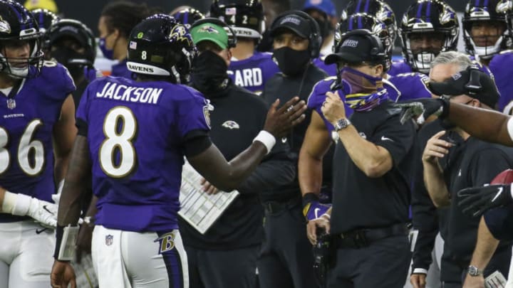 Sep 20, 2020; Houston, Texas, USA; Baltimore Ravens head coach John Harbaugh talks with quarterback Lamar Jackson (8) during the fourth quarter against the Houston Texans at NRG Stadium. Mandatory Credit: Troy Taormina-USA TODAY Sports