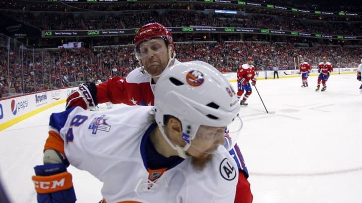 Feb 4, 2016; Washington, DC, USA; Washington Capitals defenseman Karl Alzner (27) checks New York Islanders center Mikhail Grabovski (84) in the third period at Verizon Center. The Capitals won 3-2. Mandatory Credit: Geoff Burke-USA TODAY Sports