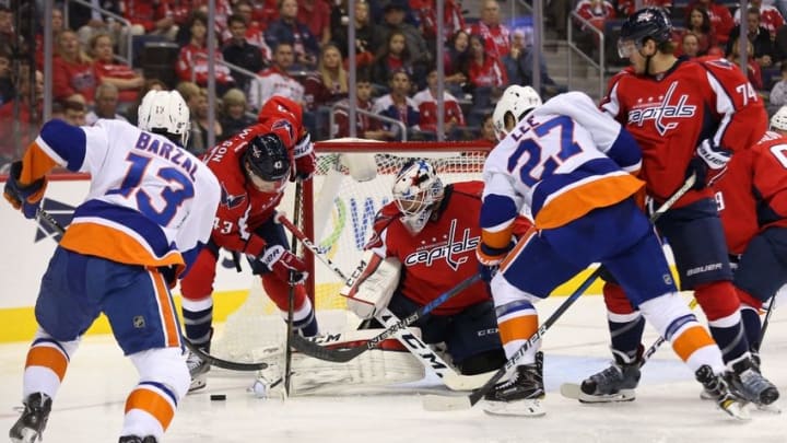 Oct 15, 2016; Washington, DC, USA; Washington Capitals goalie Braden Holtby (70) makes a save on New York Islanders left wing Anders Lee (27) in the second period at Verizon Center. Mandatory Credit: Geoff Burke-USA TODAY Sports