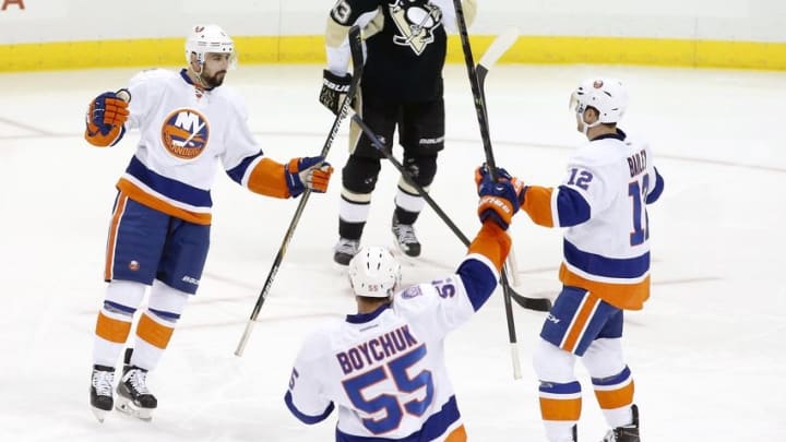 Nov 21, 2014; Pittsburgh, PA, USA; New York Islanders defenseman Nick Leddy (L) celebrates after scoring a goal with defenseman Johnny Boychuk (55) and left wing Josh Bailey (12) against the Pittsburgh Penguins during the second period at the CONSOL Energy Center. Mandatory Credit: Charles LeClaire-USA TODAY Sports