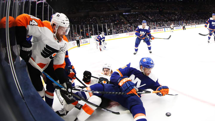 NEW YORK, NEW YORK – OCTOBER 27: Oskar Lindblom #23 of the Philadelphia Flyers battles for the puck with Johnny Boychuk #55 of the New York Islanders during their game at NYCB Live’s Nassau Coliseum on October 27, 2019 in New York City. (Photo by Al Bello/Getty Images)