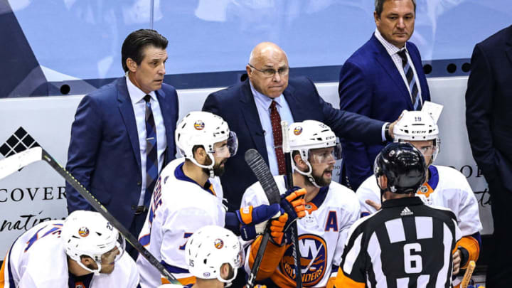 Head coach Barry Trotz of the New York Islanders speaks to referee Francis Charron #6 (Photo by Elsa/Getty Images)