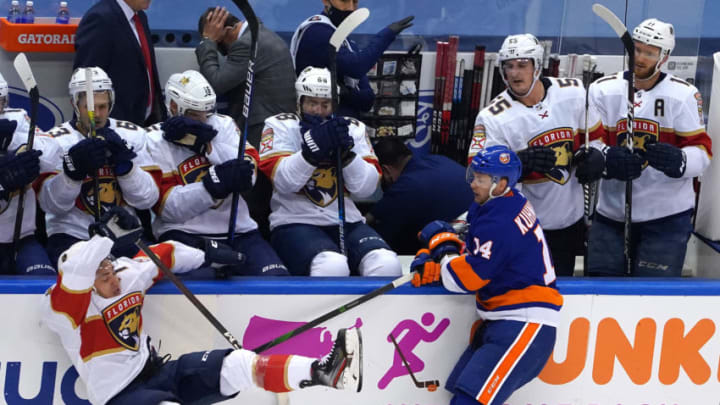 TORONTO, ONTARIO - AUGUST 01: Frank Vatrano #77 of the Florida Panthers falls to the ice after colliding with Tom Kuhnhackl #14 of the New York Islanders during the third period in Game One of the Eastern Conference Qualification Round prior to the 2020 NHL Stanley Cup Playoffs at Scotiabank Arena on August 1, 2020 in Toronto, Ontario, Canada. (Photo by Andre Ringuette/Freestyle Photo/Getty Images)