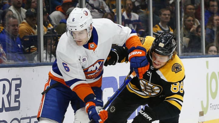 Feb 29, 2020; Uniondale, New York, USA; New York Islanders defenseman Ryan Pulock (6) and Boston Bruins right wing David Pastrnak (88) battle for position during the first period at Nassau Veterans Memorial Coliseum. Mandatory Credit: Andy Marlin-USA TODAY Sports