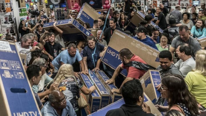 People participate in a "Black Friday" event in São Paulo, Brazil, on November 23, 2018. "Black Friday" is a term created in the United States to cite the day of big business that is celebrated the next day from Action Thanks, and that in Brazil began to happen in 2010. (Photo by Cris Faga/NurPhoto via Getty Images)