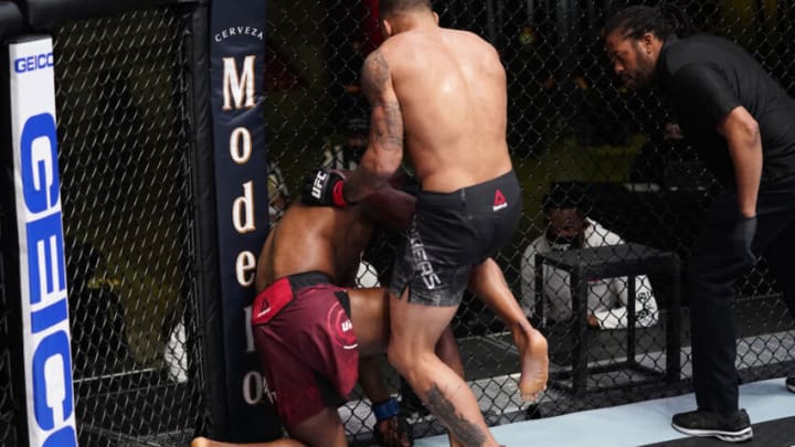 LAS VEGAS, NEVADA - MARCH 13: In this handout image provided by UFC, (R-L) Eryk Anders lands an illegal knee against Darren Stewart of England in a middleweight fight during the UFC Fight Night event at UFC APEX on March 13, 2021 in Las Vegas, Nevada. (Photo by Jeff Bottari/Zuffa LLC via Getty Images)