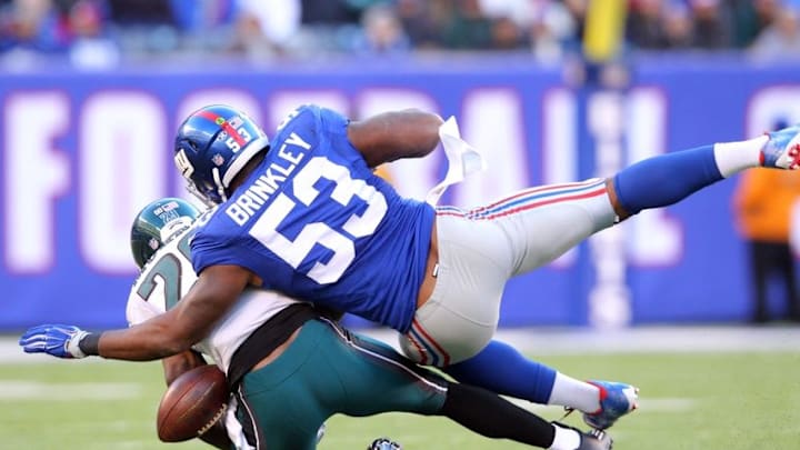 Jan 3, 2016; East Rutherford, NJ, USA; Philadelphia Eagles running back DeMarco Murray (29) fumbles the ball after being hit by New York Giants linebacker Jasper Brinkley (53) during the third quarter at MetLife Stadium. The Eagles won 35-30. Mandatory Credit: Brad Penner-USA TODAY Sports