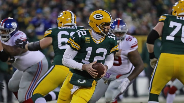 GREEN BAY, WI – JANUARY 08: Aaron Rodgers #12 of the Green Bay Packers rolls out to look for a receiver against the New York Giants at Lambeau Field on January 8, 2017 in Green Bay, Wisconsin. (Photo by Jonathan Daniel/Getty Images)