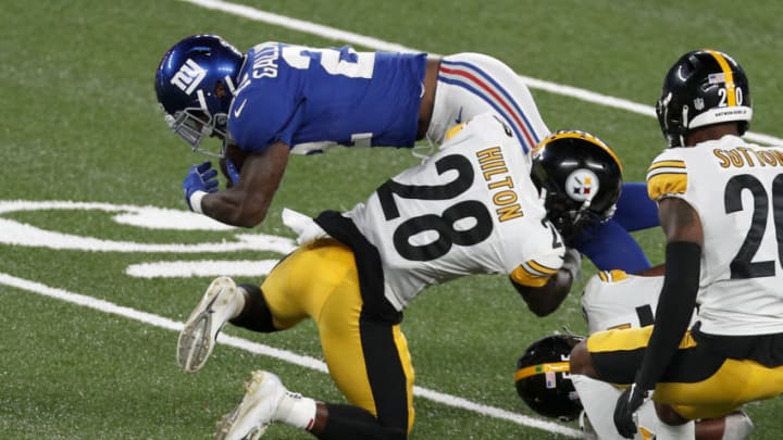 EAST RUTHERFORD, NEW JERSEY - SEPTEMBER 14: (NEW YORK DAILIES OUT) Wayne Gallman #22 of the New York Giants in action against Mike Hilton #28 of the Pittsburgh Steelers at MetLife Stadium on September 14, 2020 in East Rutherford, New Jersey. The Steelers defeated the Giants 26-16. (Photo by Jim McIsaac/Getty Images)