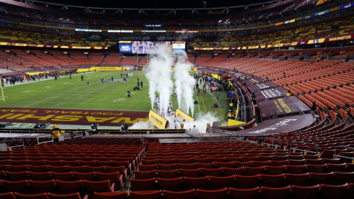 LANDOVER, MARYLAND - JANUARY 09: Washington Football Team players run onto the field prior to the game against the Tampa Bay Buccaneers at FedExField on January 09, 2021 in Landover, Maryland. (Photo by Rob Carr/Getty Images)