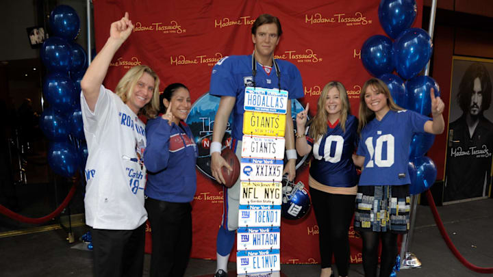 NEW YORK, NY – FEBRUARY 01: Joe “License Plate Guy” Ruback (L) and fans pose for photos with the wax figure of Eli Manning at Madame Tussauds on February 1, 2012 in New York City. (Photo by Ilya S. Savenok/Getty Images)–––––