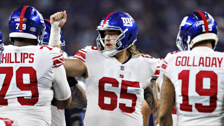 ARLINGTON, TEXAS – NOVEMBER 24: Nick Gates #65 of the New York Giants in the huddle during a game against the Dallas Cowboys at AT&T Stadium on November 24, 2022 in Arlington, Texas. The Cowboys defeated the Giants 28-20. (Photo by Wesley Hitt/Getty Images)